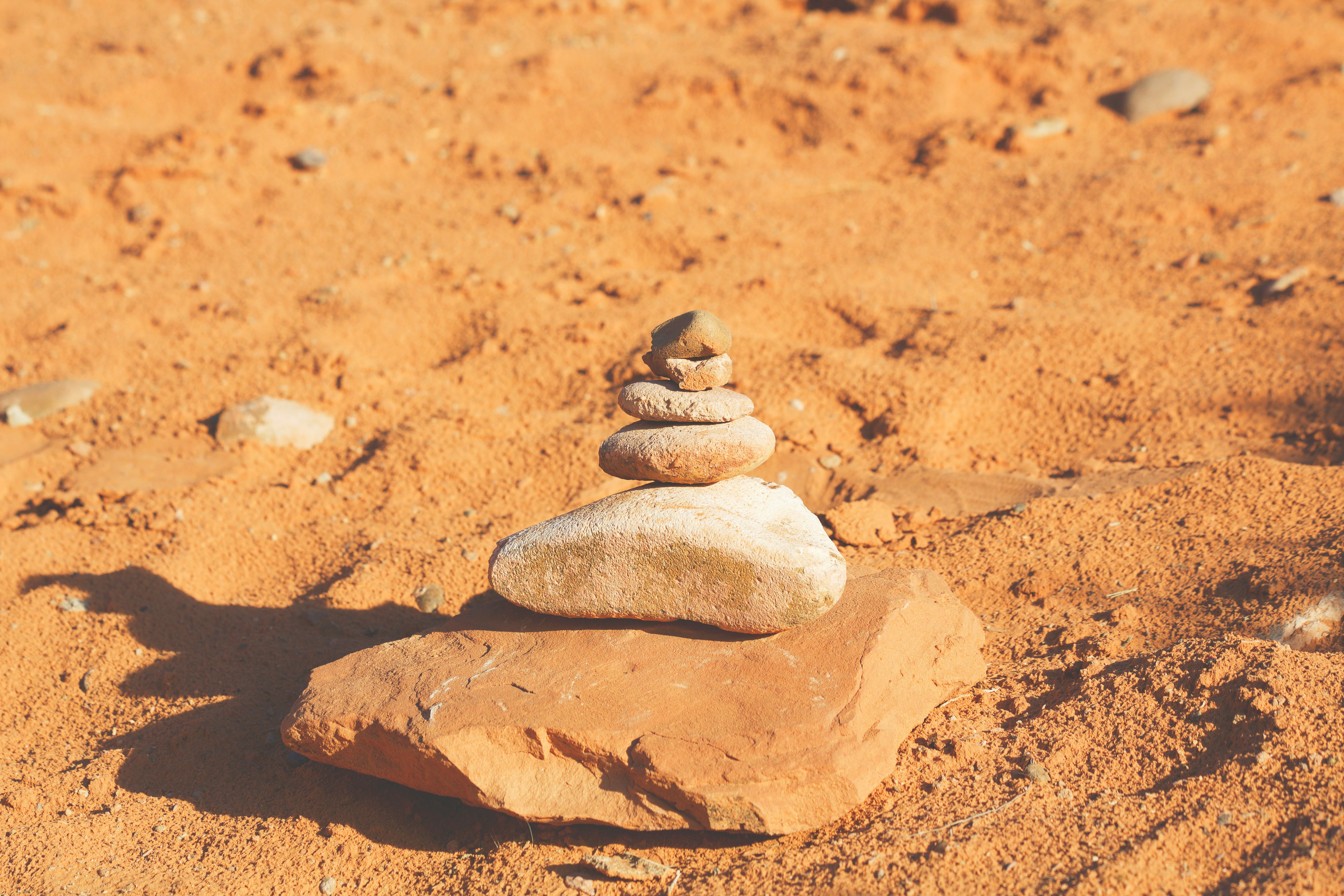 closeup photography of piling stone on sand